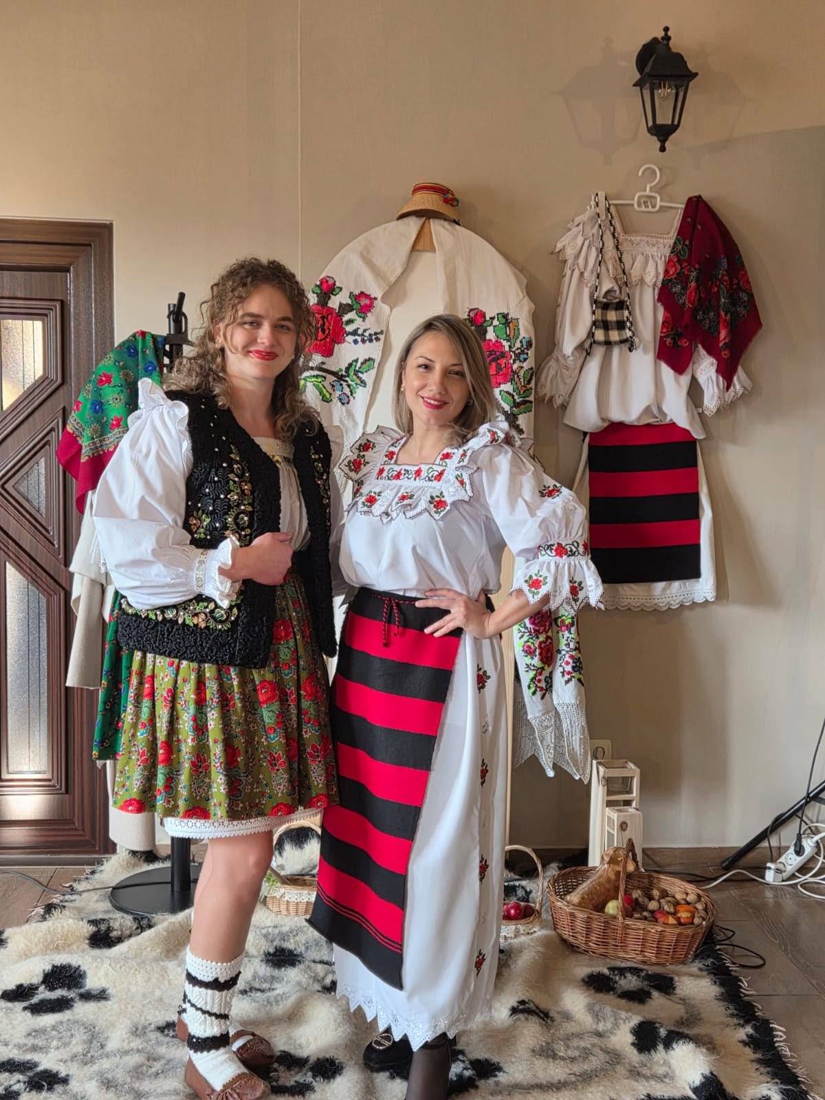 Two guests dressed in Maramureș folk costume, at the guesthouse.